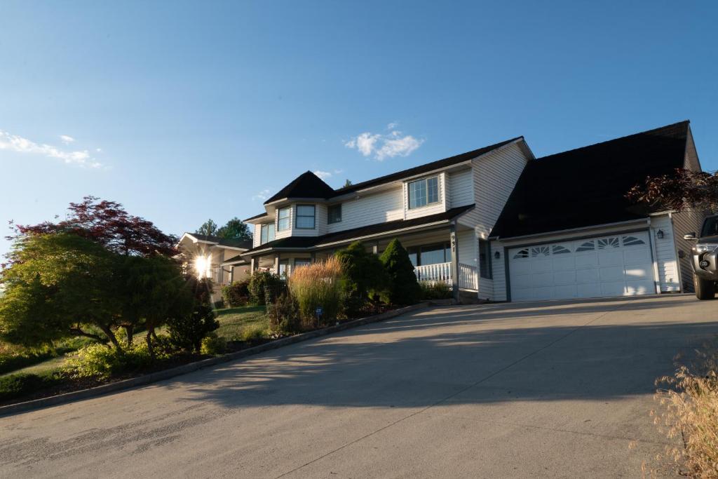 a large white house with a driveway at KnoxPeace BnB in Kelowna