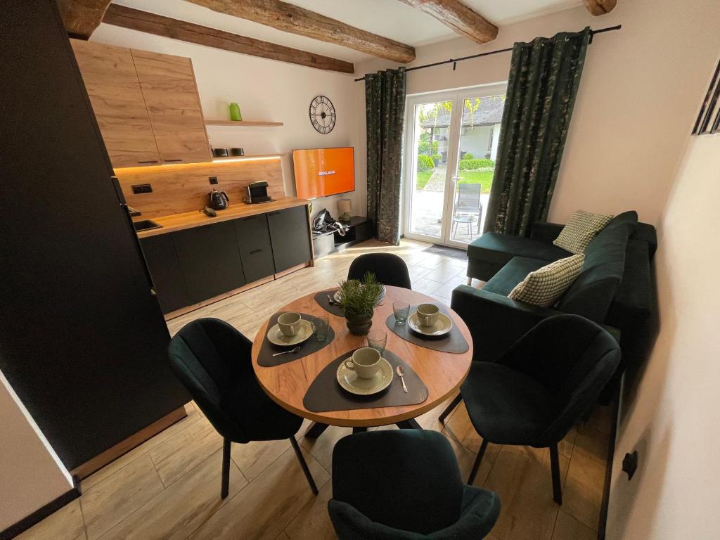a living room with a table and chairs at Agroturystyka u Iwony in Wiekowo