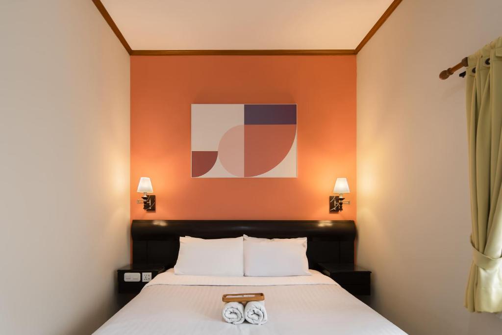 a bedroom with a bed with two slippers on it at Cove Rumah Asri in Bandung