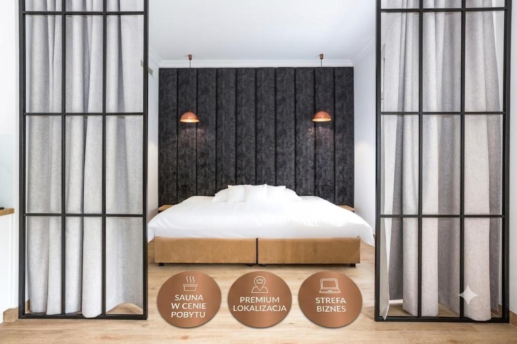 a bedroom with a bed and two signs in front of it at Europejski Boutique Hotel in Radom