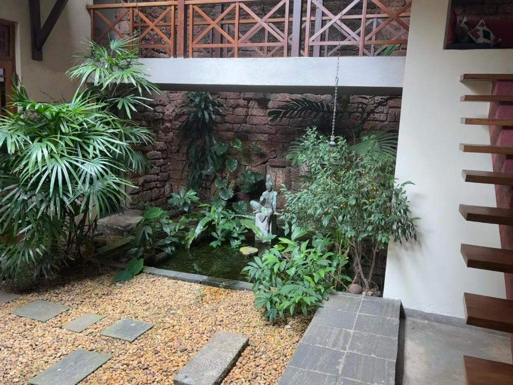 a garden in front of a building with a pond at Highbury Colombo in Colombo