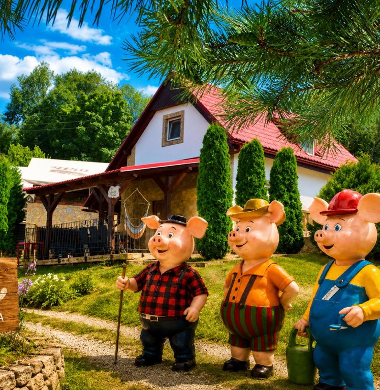 three cartoon characters standing in front of a house at Apartmánový dom v Panoráma Parku in Nezbudská Lúčka