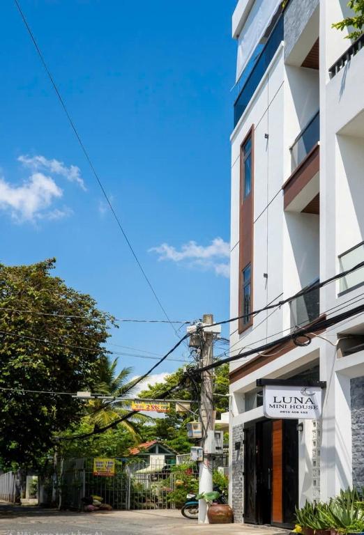 a building with a sign on the side of it at LUNA House in Can Tho