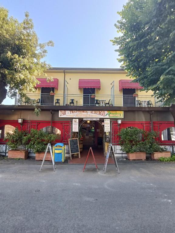 a building with a sign in front of it at Maurin in Carrara