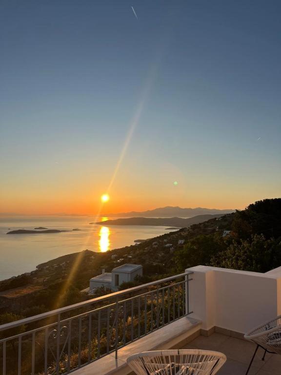 a view of the sunset from the balcony of a house at Aegean Mirror Andros in Apróvaton