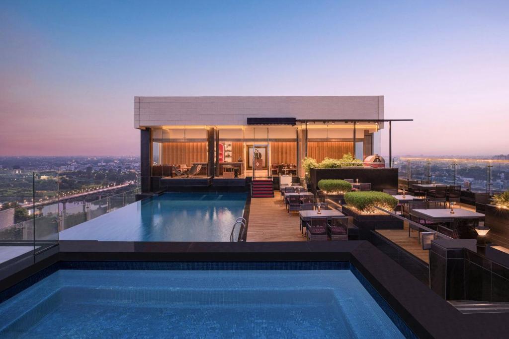 a swimming pool on the roof of a building at Renaissance Lucknow Hotel, Gomti Nagar in Lucknow