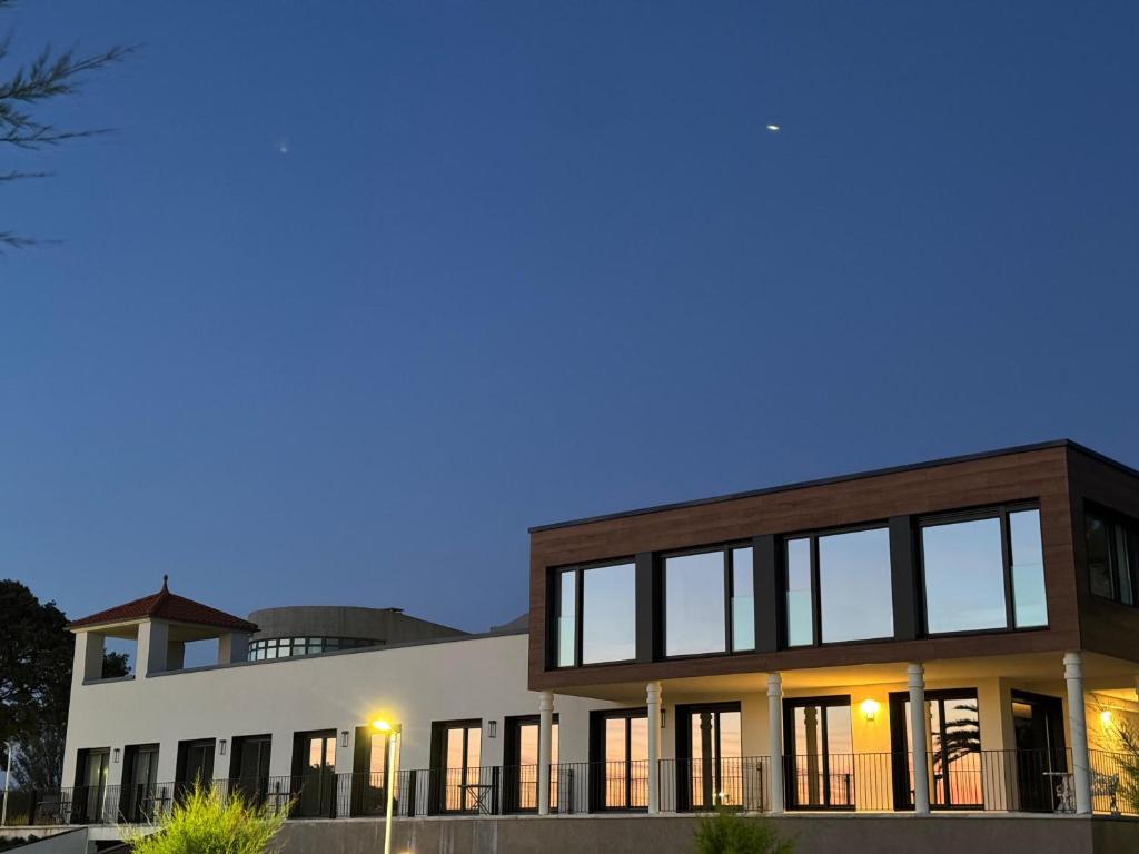 a building with large windows at night at Apartamentos turísticos El Pinar in Mogro