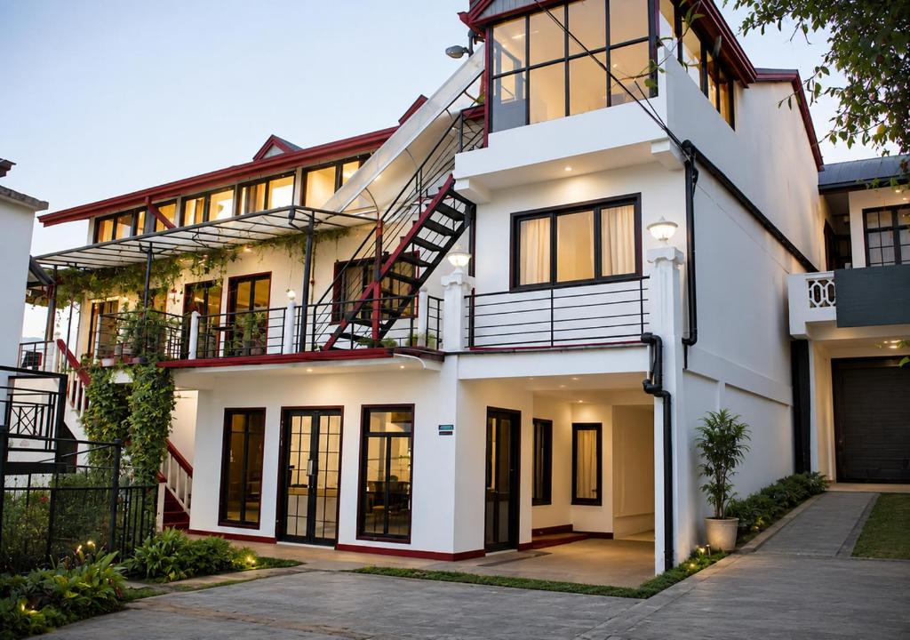 a white house with a lot of windows at Sanara Hotel in Nuwara Eliya