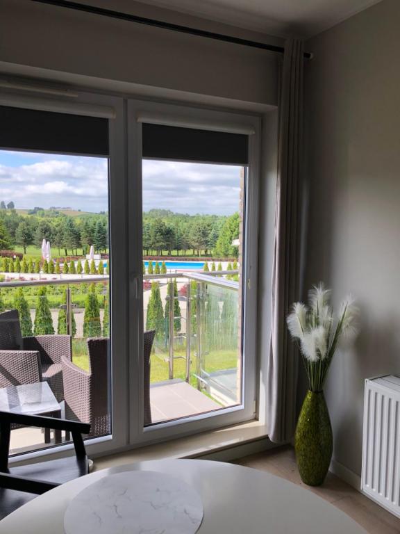 a room with a window with a view of a patio at Golf Apartament 10 in Wejherowo