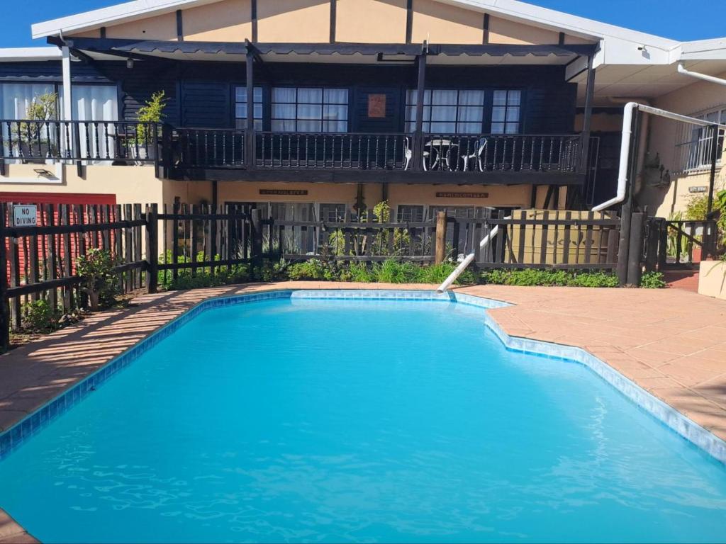 a swimming pool in front of a house at A1Bay View Guest House Cottage & Apartment SEA FACING in Jeffreys Bay