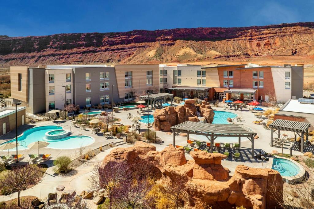 an aerial view of a resort with a pool at SpringHill Suites by Marriott Moab in Moab