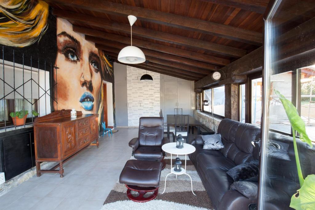 a living room with a couch and a painting of a woman at Aberasturi in Gautegiz Arteaga