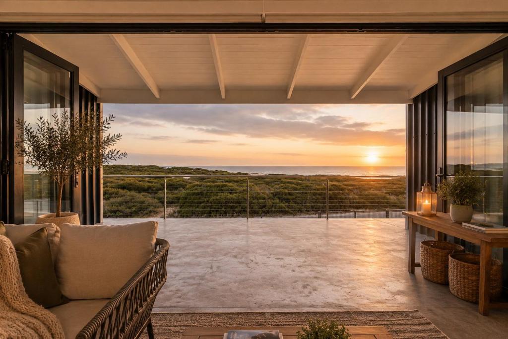 a living room with a couch and a view of the ocean at Sea Mist Villa in Pearly Beach
