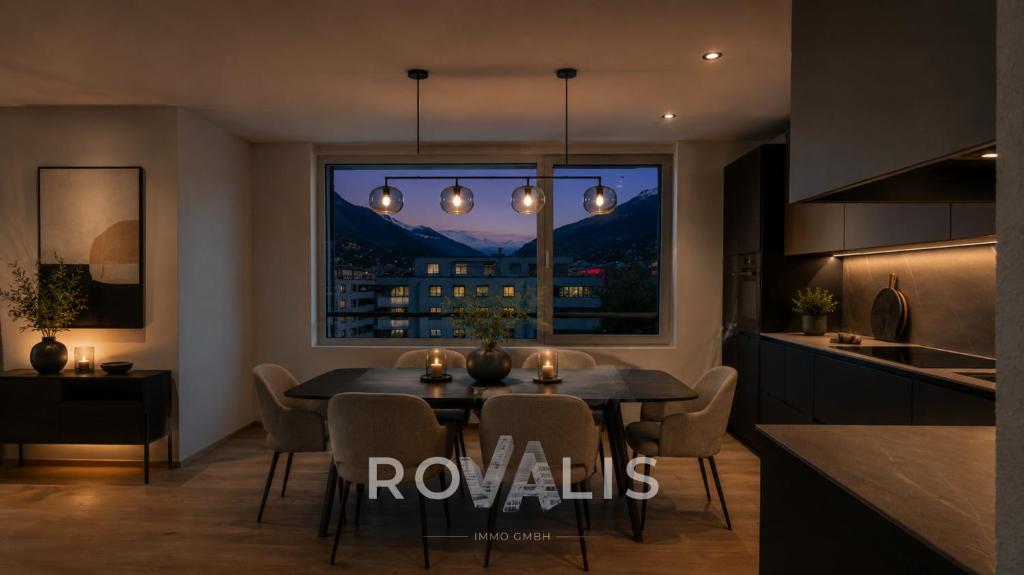 a kitchen and dining room with a table and a window at Brig Panorama Spa in Brig