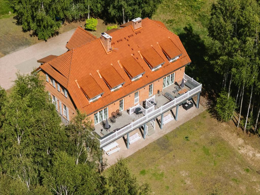 an overhead view of a large house with an orange roof at Przystań Piecek in Stręgielek