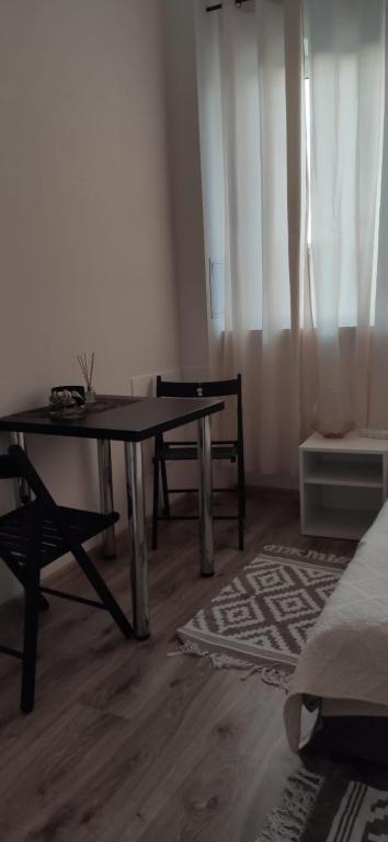 a living room with a table and chairs and a couch at Century hostel in Gdynia