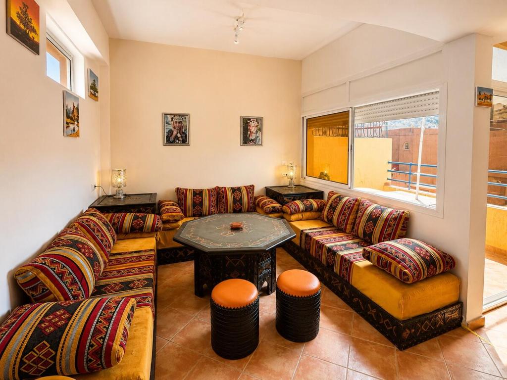 a living room with a couch and a table at House Soleil in Agadir nʼ Aït Sa