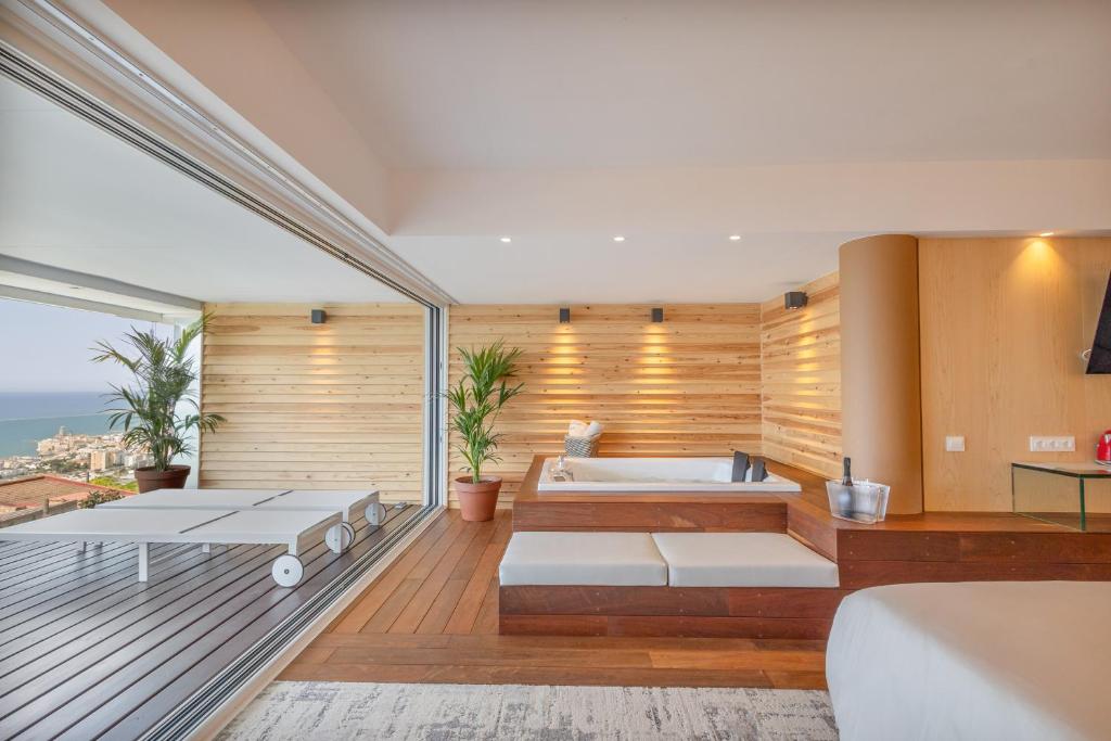 a room with a bath tub and a room with a tub at Sitges Suites - Premium in Sitges
