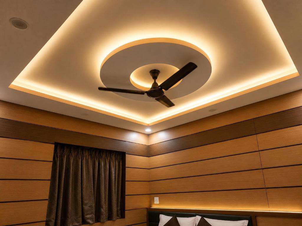 a coffered ceiling with a ceiling fan in a room at Orbit guest house by Flying Suites in Kolkata