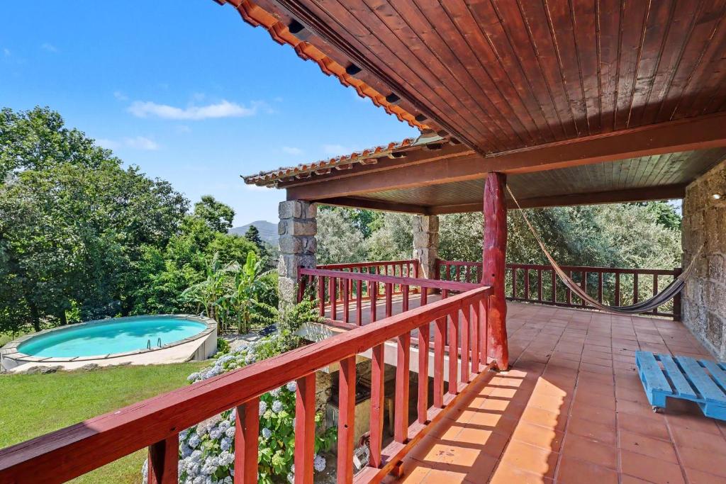 an outdoor deck with a pool and a hot tub at Casa Nova das Oliveiras in Verim
