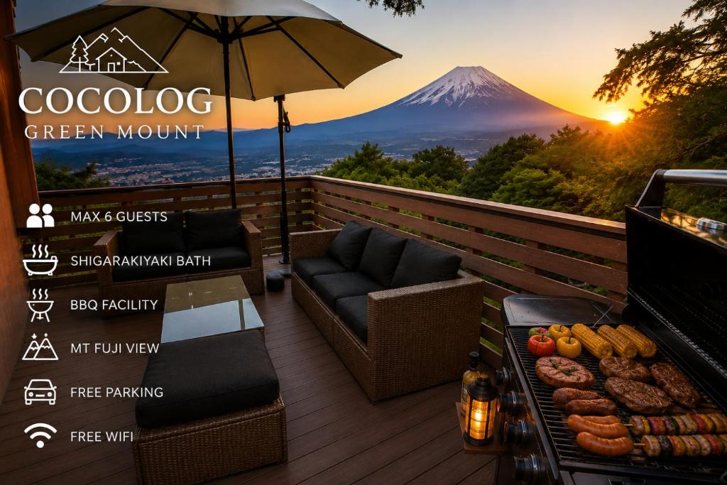 a patio with an umbrella and a grill with a mountain at Ranked 1 in the Izu Mount Fuji from the villa in Izunokuni