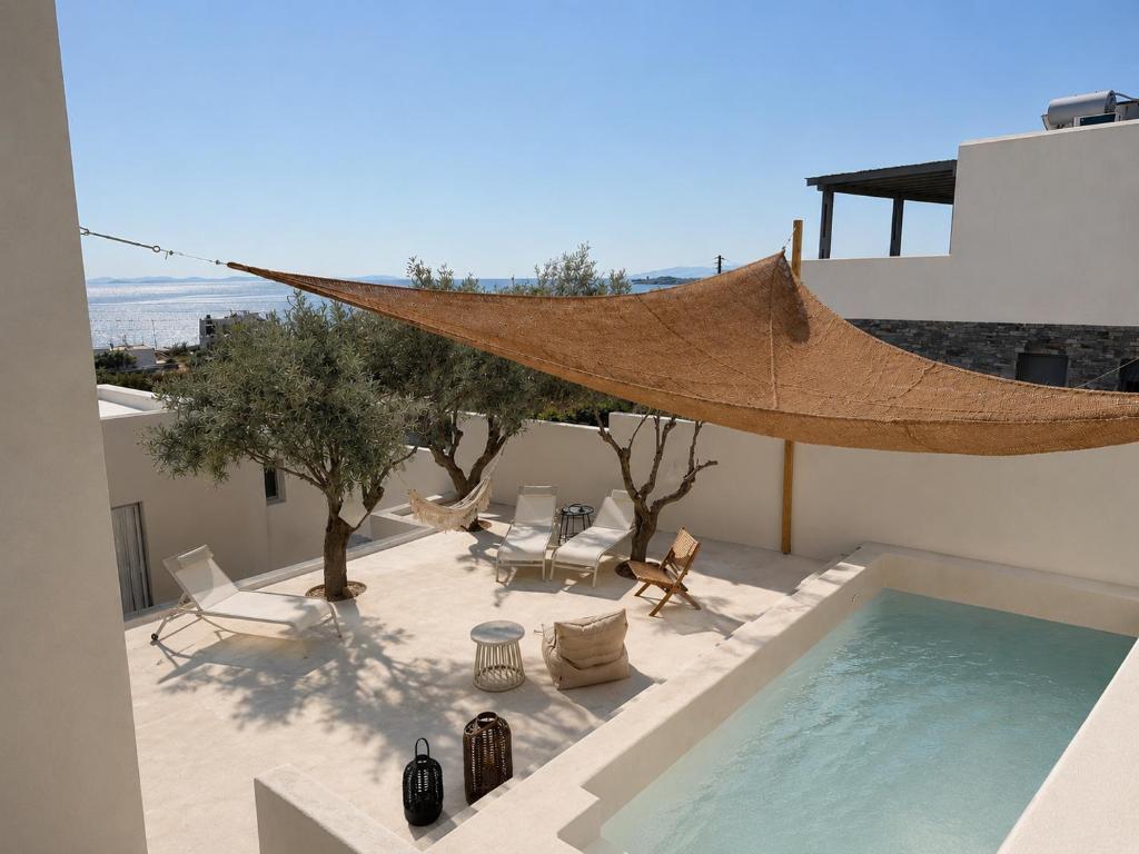 a patio with a hammock and a swimming pool at Syros-house in Azolimnos Syros