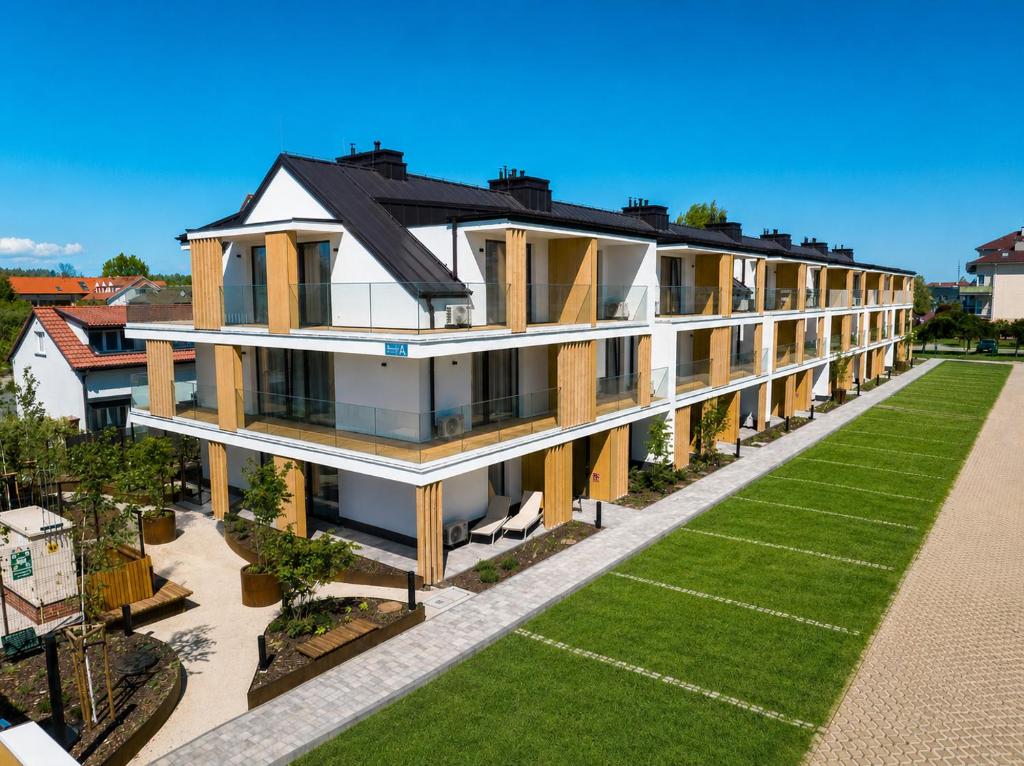 an aerial view of a building with a yard at Baltic Season Spa Apartments in Grzybowo