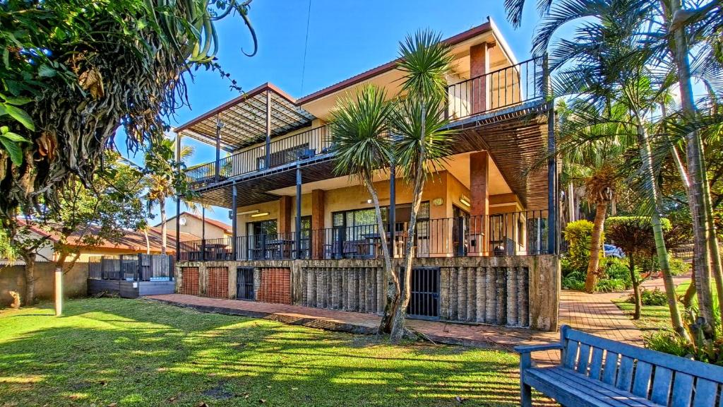 a house with a bench in front of it at Konrad 8 in Uvongo Beach