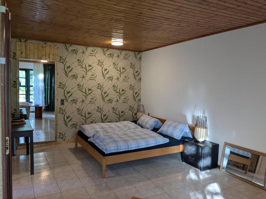 a bedroom with a bed and a wall at Monteur Budget Zimmer in Schöppenstedt