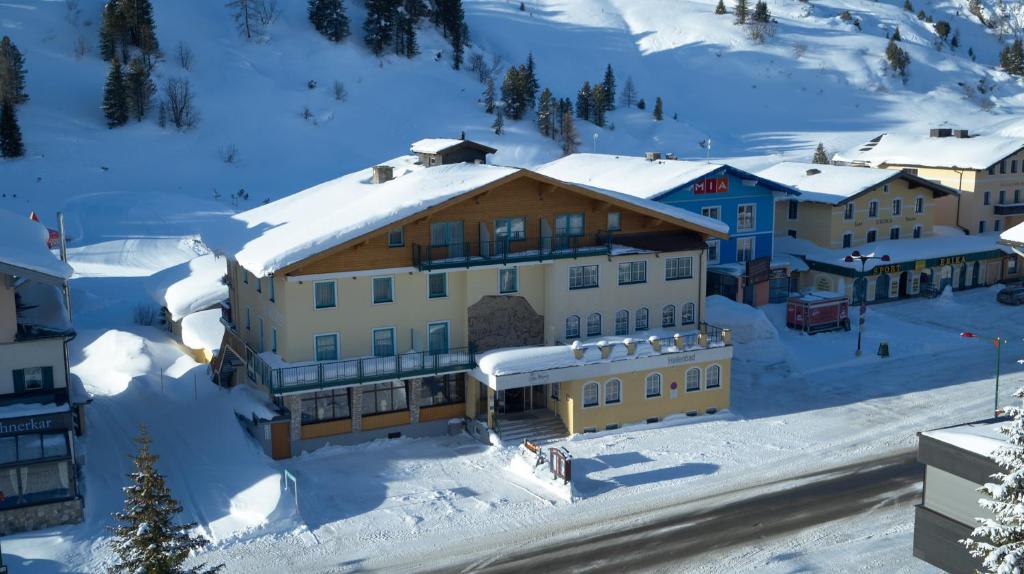 a town in the snow with a building at Hotel Wagner in Obertauern