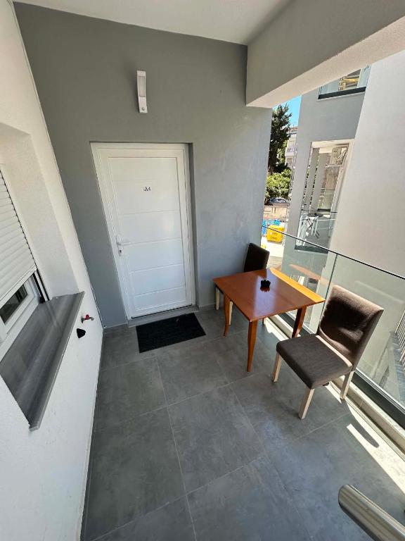 a room with a table and chairs and a door at Sunset Apartment A-4 in Perea