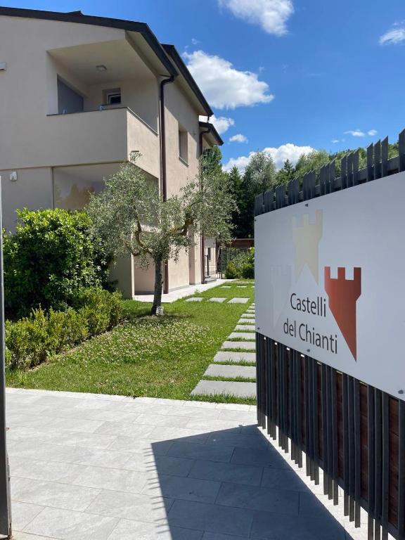 a sign on a fence in front of a building at Castelli del Chianti in Gaiole in Chianti