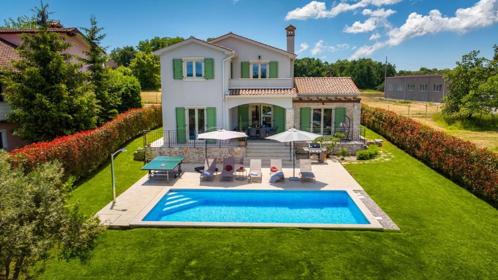 an aerial view of a house with a swimming pool at Villa Bartol in Trviž