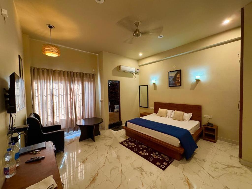 a bedroom with a bed and a desk in a room at Green hillock hotel in Alwar