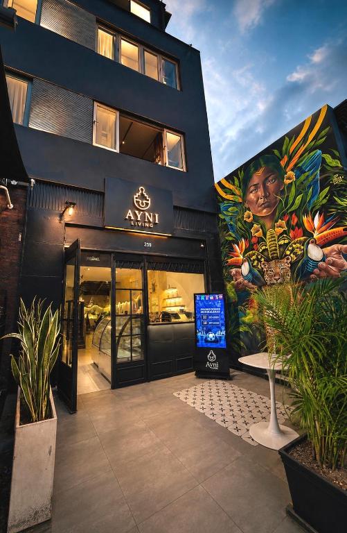 a building with a large mural on the side of it at Ayni Living - Hostel in Lima
