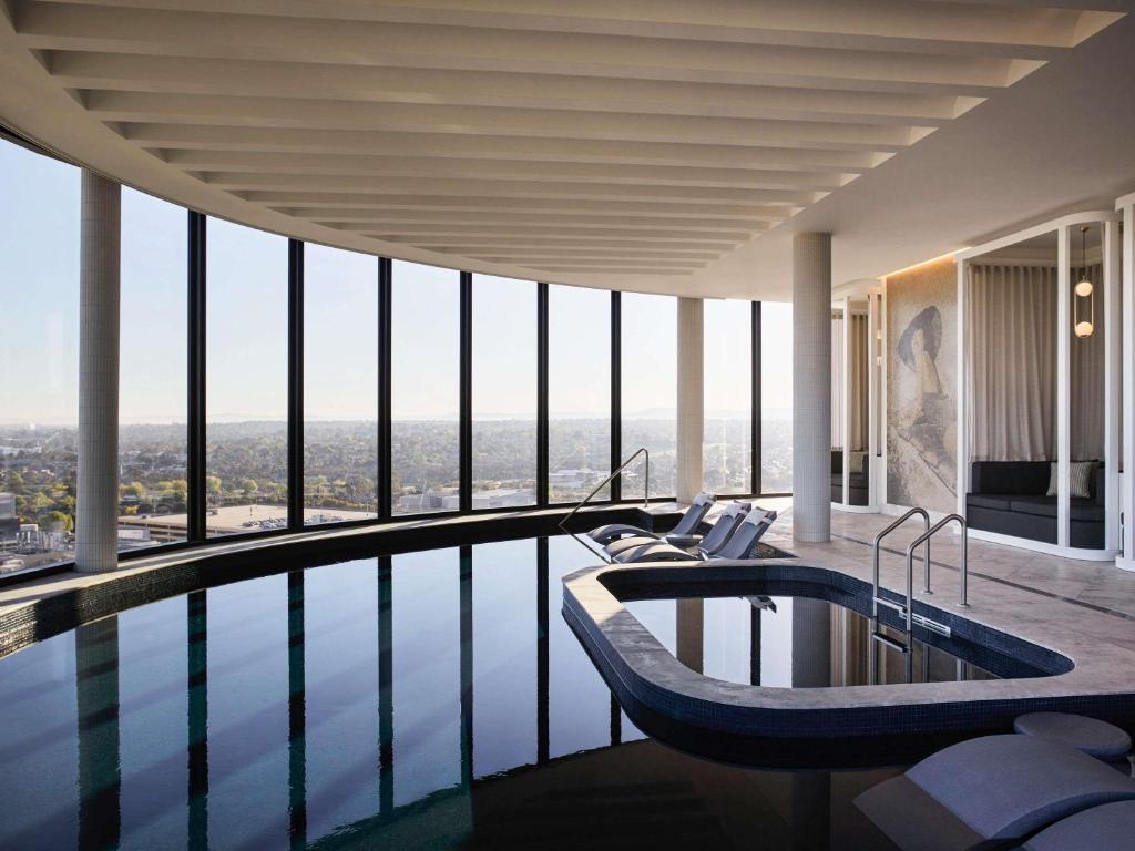 a swimming pool with a tub in a building at Hotel Chadstone Melbourne MGallery Collection in Chadstone