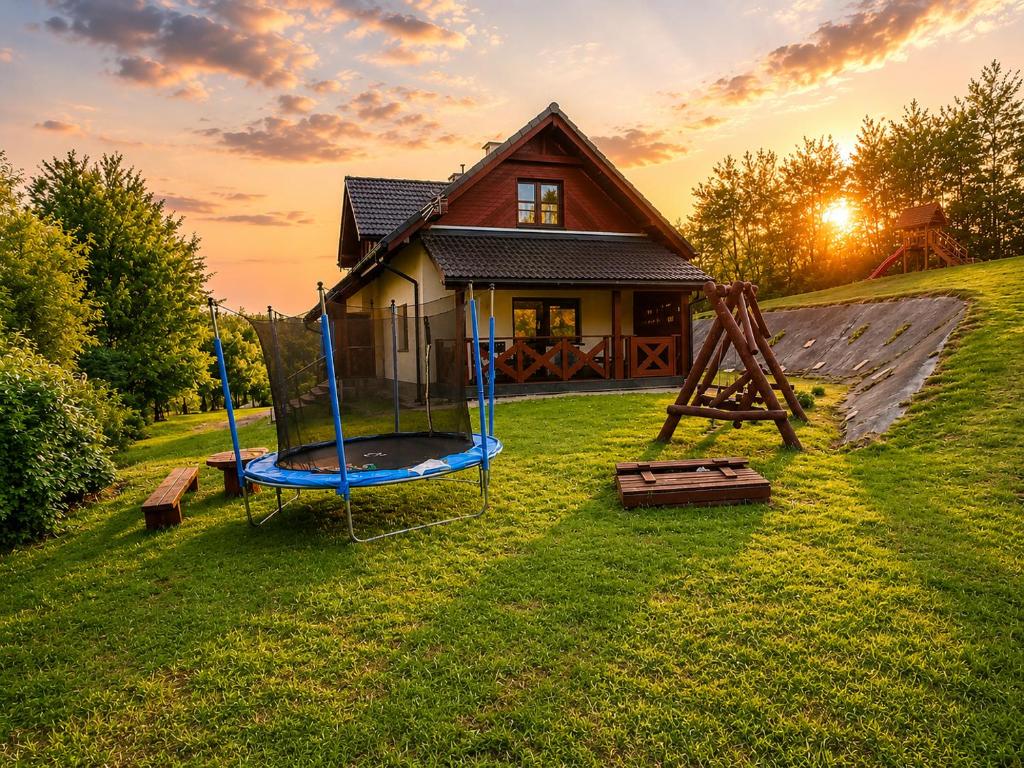 a house with a playground in the yard at Dom u Braci in Wołkowyja