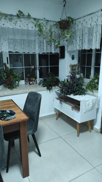 a living room with a table and chairs and windows at בית שבט אחים in Hatzor haglilit