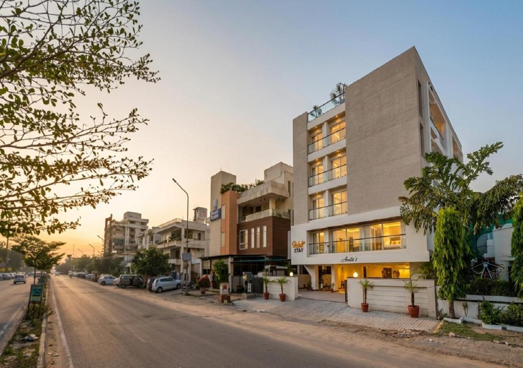 a building on the side of a street at Palm Stay - Studios & Rooms in Jaipur