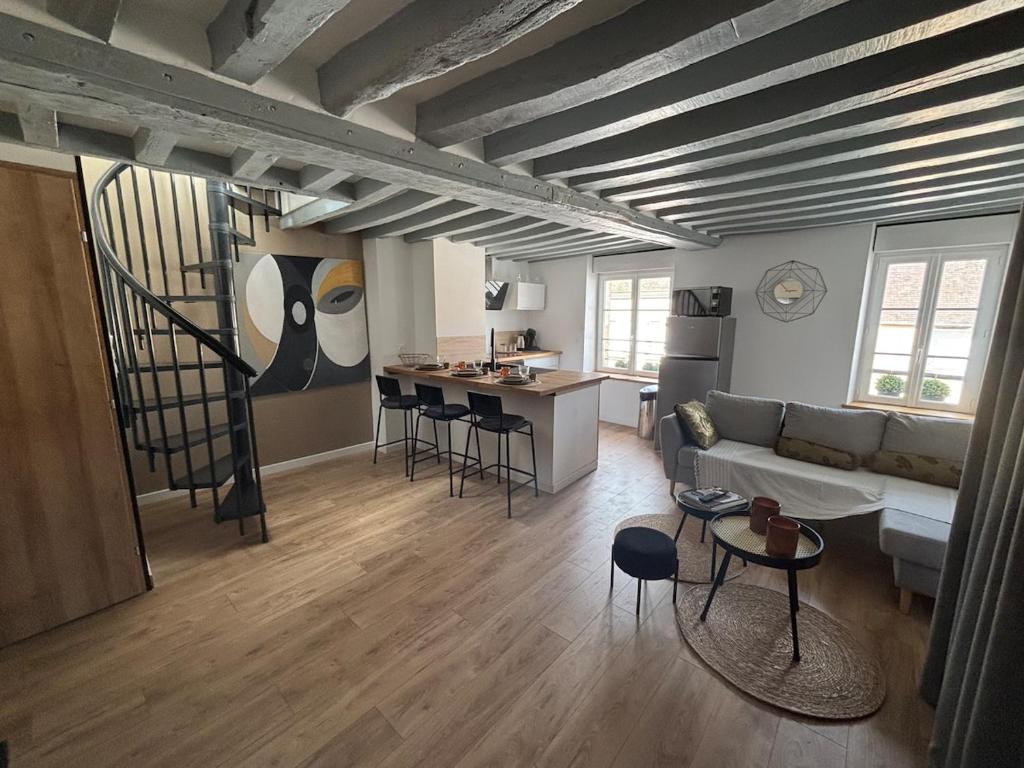 a living room with a couch and a table at La clé du Temps in Falaise