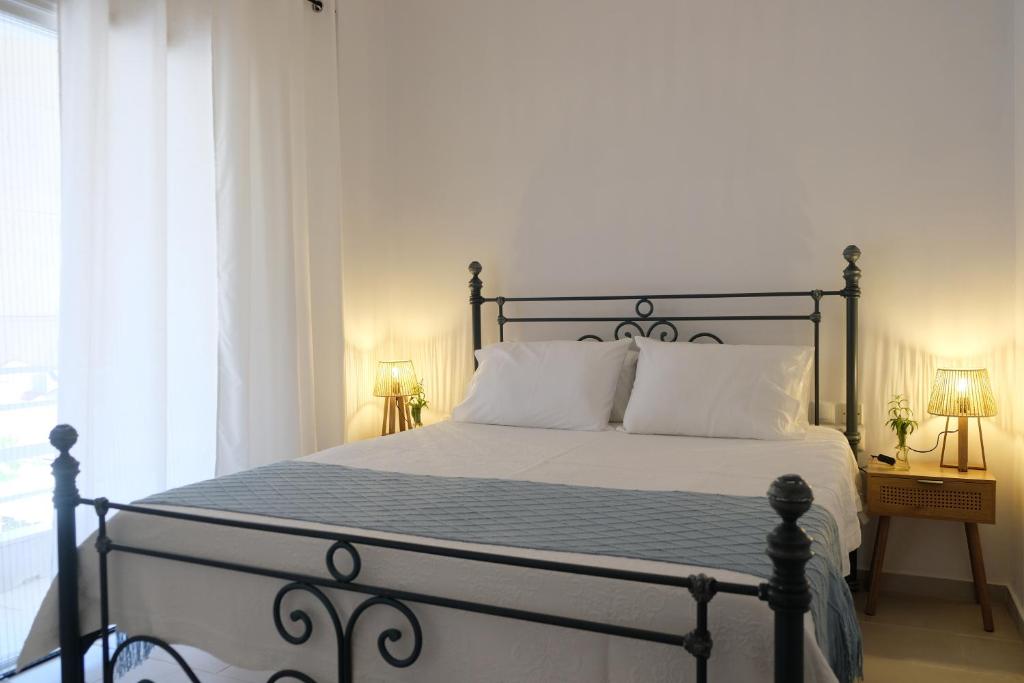 a bedroom with a large bed with white pillows at Lydía Residence - Mantoudi Evia in Mantoúdion