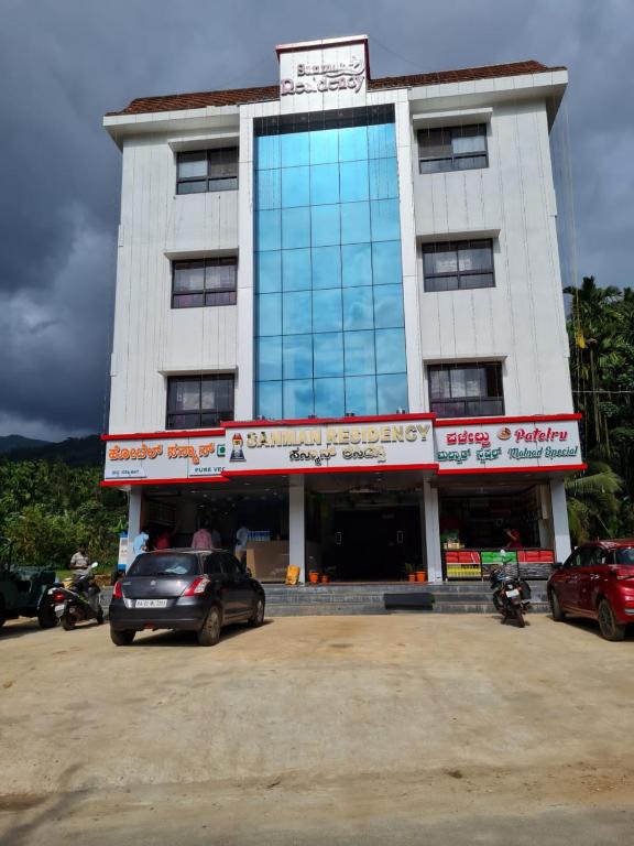 a building with a car parked in front of it at Horanadu Sanman residency in Kalasa