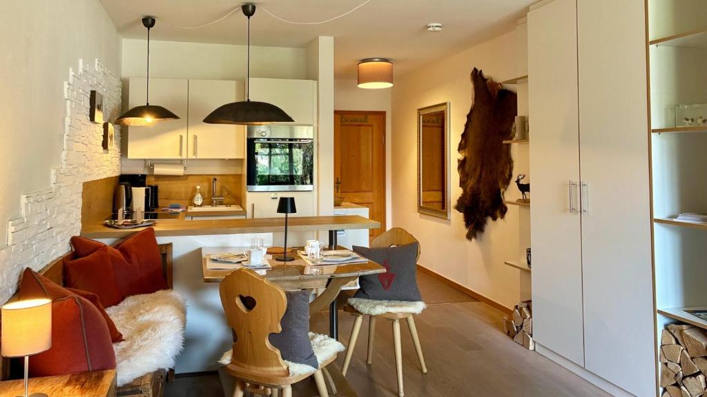 a kitchen with a table and chairs in a room at FeWo Rottachglück in Tegernsee