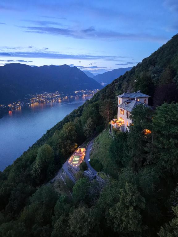 a building on the side of a hill next to a lake at Villa Jolanda, a Garamonds Property in Brunate