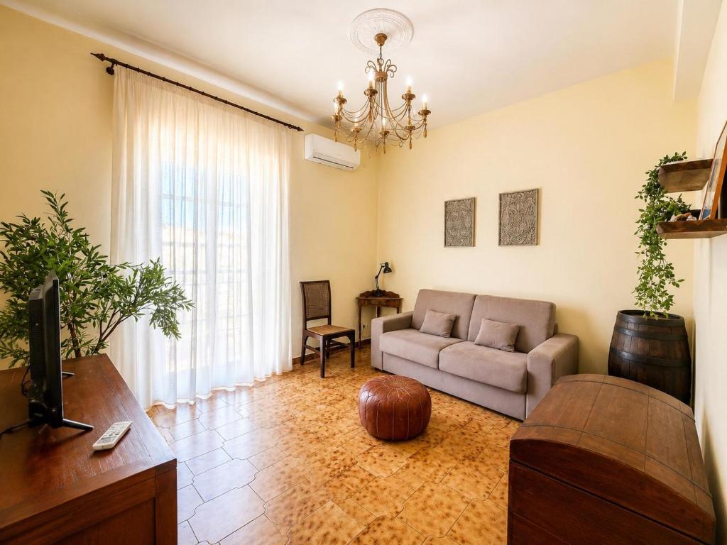 a living room with a couch and a tv at La Casita Del Mar in San Vito lo Capo