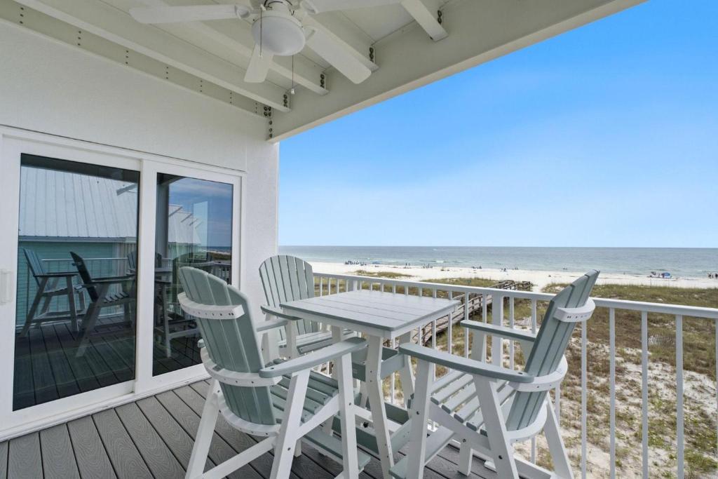 a table and chairs on a balcony with the beach at Riviera Dunes 203 in Perdido Key