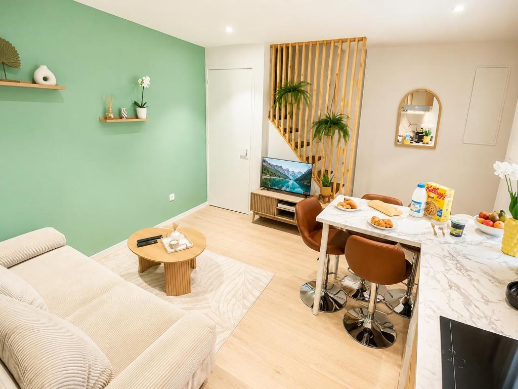 a living room with a couch and a table at " Petit Nid Muretain " Arrivée autonome - Wifi in Muret
