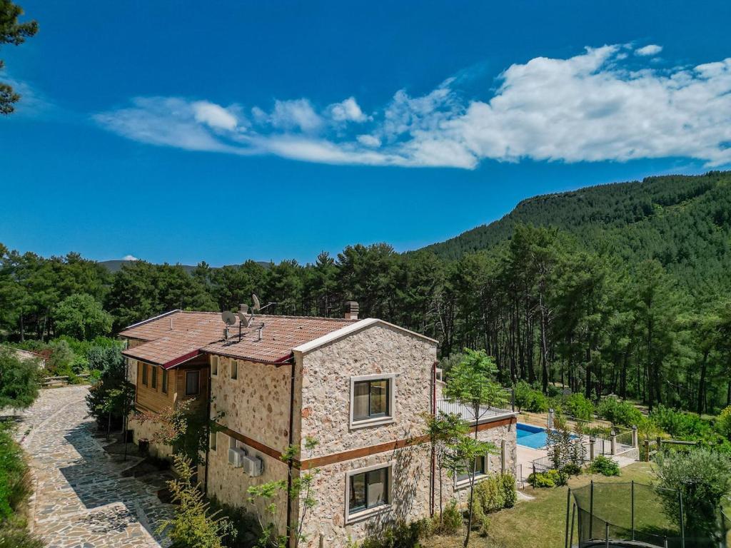 an aerial view of a house in the mountains at Han Villa in Kaş