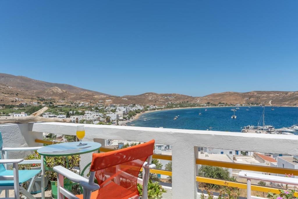 a balcony with a table and chairs and a view of the ocean at Agnadi Apartment in Serifos Chora