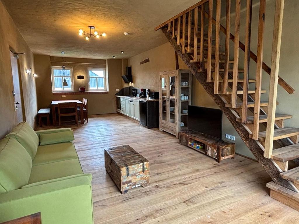 a living room with a couch and a staircase at Brühlbach-Blick in Morbach